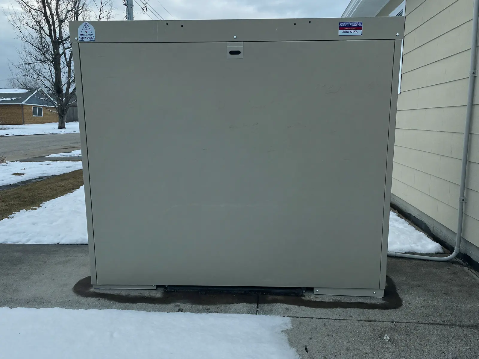 Standby home generator beside a house